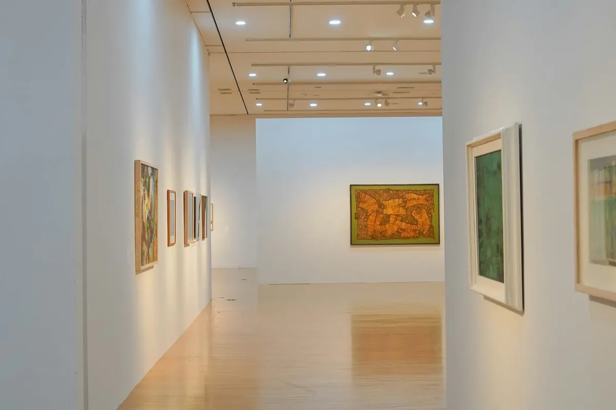 Paintings on a plain white gallery wall