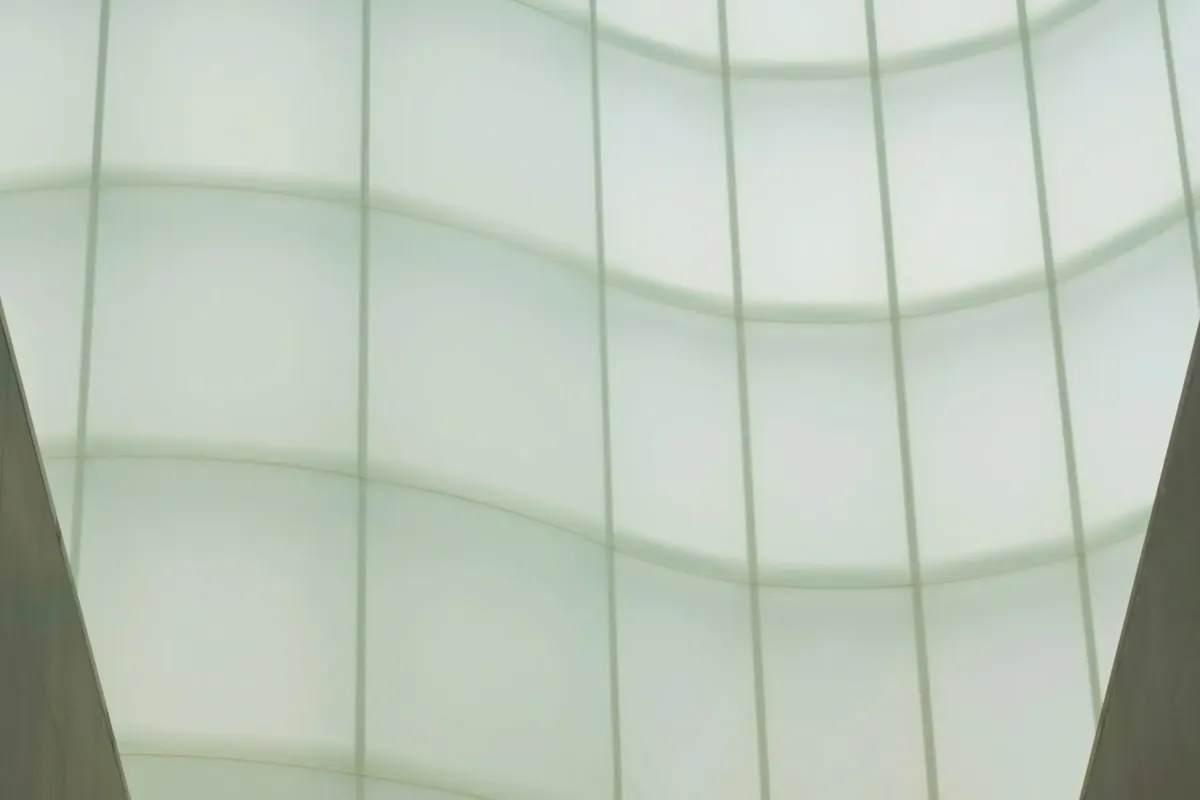 A staircase rising toward an illuminated wavy ceiling
